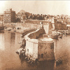 View of the entrance to the port, shortly before demolition work began on the small Koules. The Fytakis Mansion, Heraklion''s first high-rise building, is visible in the background, 1936 (Yiannis Perdikoyiannis Collection)